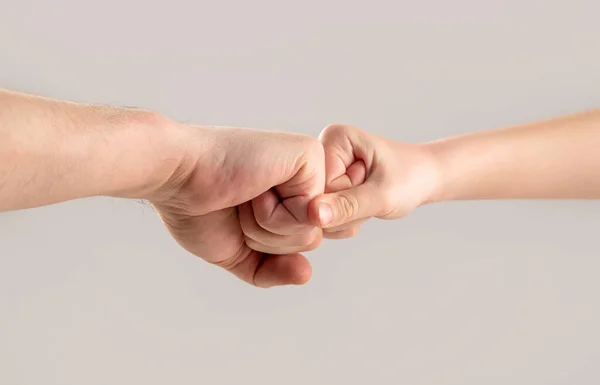 Two hands: man and child. Father and son touching fists. Old man and kid holding hands together. Little and big fists of father and son. Mother and kid daughter are fist bumping — Stockfoto
