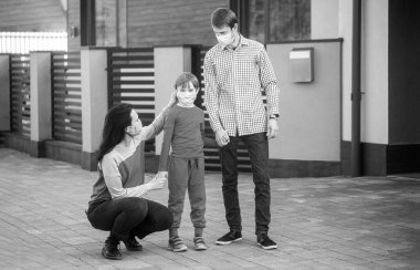 Coronavirus karantinası. Aile yürüyüşe çıkıyor. Coronavirus, hastalık, enfeksiyon, karantina, tıbbi maskeler, COVID-19. Siyah ve beyaz