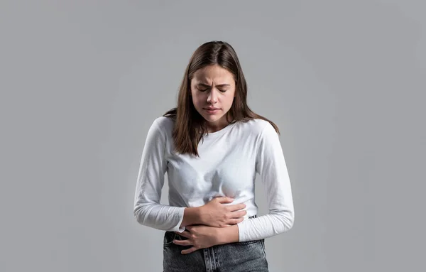 Woman Stomach Ache. Woman touching his stomach. Stomach pain and others stomach disease concept.Girl having a stomachache. Young woman suffering from abdominal pain