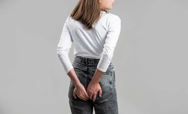 A woman holds his hands to the ass feeling pain. Hemorrhoids. Anus. Ass Pain. Woman hand holding her bottom because having Abdominal pain and Hemorrhoids. Woman suffering from hemorrhoids, anal pain — ストック写真