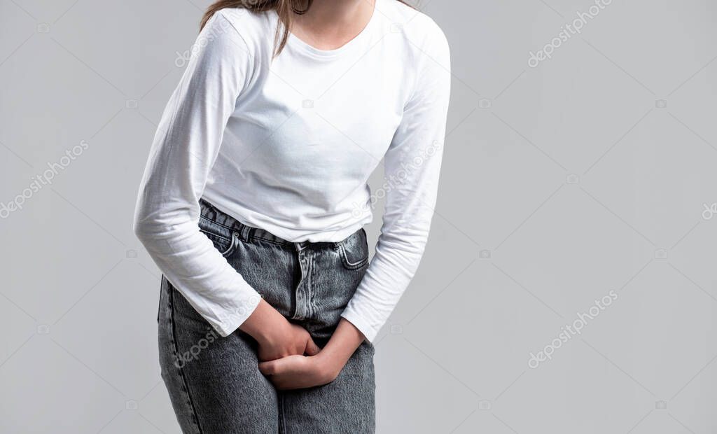 Woman Hands Holding Her Crotch. Sick woman hands holding pressing her crotch lower abdomen. Medical or gynecological problems, healthcare concept. Close up of a woman with hands holding her crotch