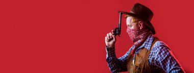 Portrait of a cowboy. American bandit in mask, western man with hat. Portrait of cowboy in hat. Portrait of man wearing cowboy hat, gun. Portrait of a cowboy. West, guns