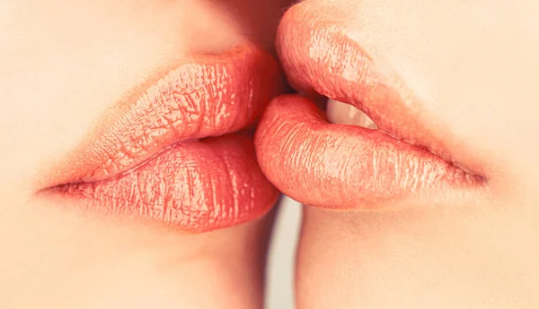 Lip care and beauty. Closeup of beautiful young woman healthy lips. Lesbian couple kiss lips. Passion and sensual touch. Closeup of women mouths kissing. Two beautiful sexy lesbians in love — kuvapankkivalokuva