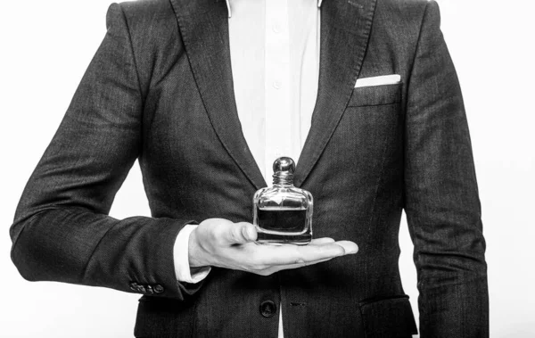 Perfume or cologne bottle and perfumery, cosmetics, scent cologne bottle, male holding cologne. Male holding up bottle perfume. Black and white — Stock Photo, Image