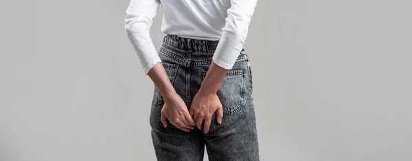 Woman suffering from hemorrhoids, anal pain. A woman holds his hands to the ass feeling pain. Hemorrhoids. Anus. Ass Pain. Woman hand holding her bottom because having Abdominal pain and Hemorrhoids — Foto de Stock