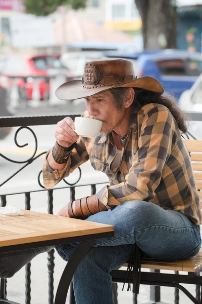 Aziatische cowboy met een kopje koffie — Stockfoto