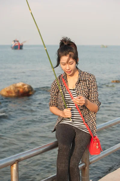 Girl with a fishing rod — Stock Photo, Image