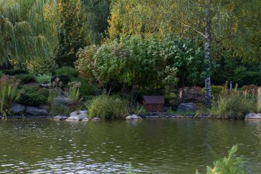 Small house for birds and ducks floating in the water in the park