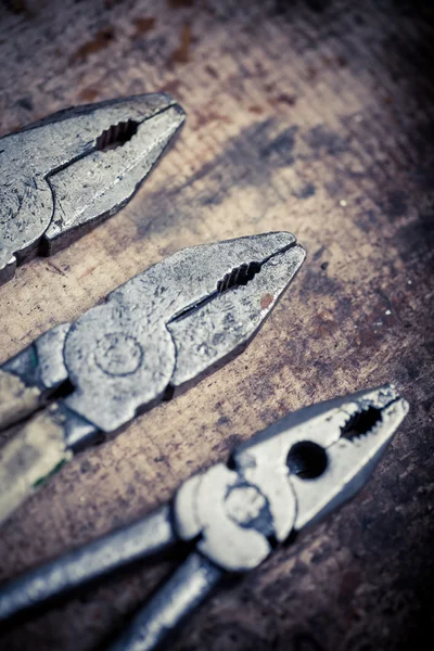 Pliers on wooden plank — Stock Photo, Image