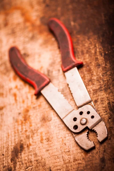 Wire stripper on wooden plank — Stock Photo, Image