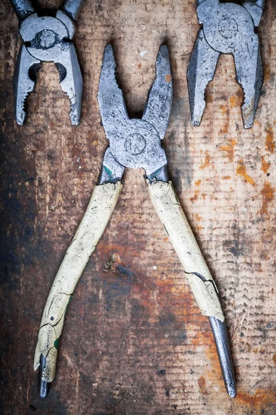 Pliers on wooden plank — Stock Photo, Image