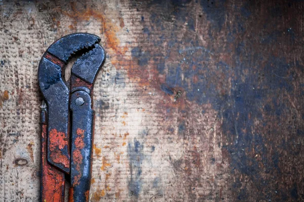 Adjustable spanner on wooden plank — Stock Photo, Image