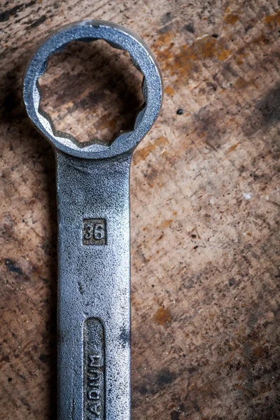 Ring wrench on wooden plank — Stock Photo, Image