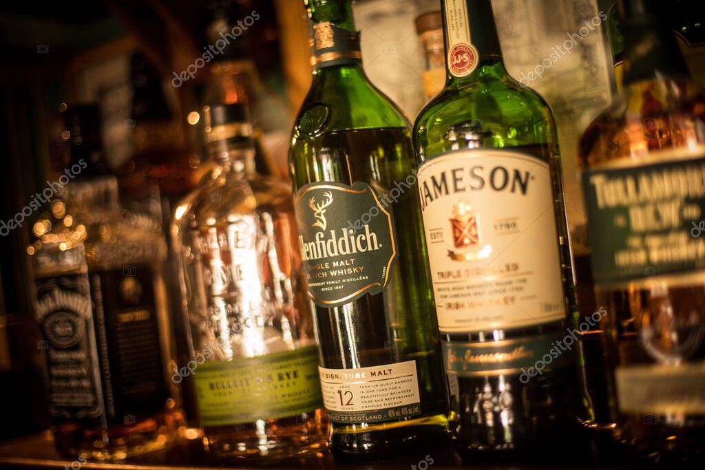 Bucharest, Romania - July 14, 2020: Illustrative editorial image of various whisky bottles displayed in a pub in Bucharest, Romania.