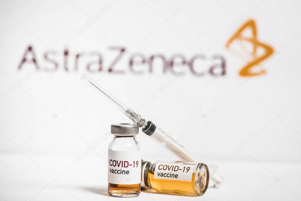 Bucharest, ROMANIA - March 15, 2021: Illustrative editorial concept image with a dose of the new Coronavirus COVID-19 vaccine, with the AstraZeneca logo in the background.