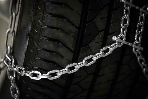 Snow chains on tire — Stock Photo, Image