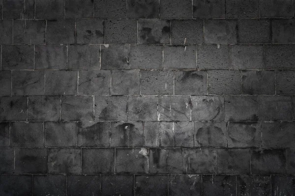 Mattoni grigio scuro sulla decorazione della parete per lo sfondo. — Foto Stock