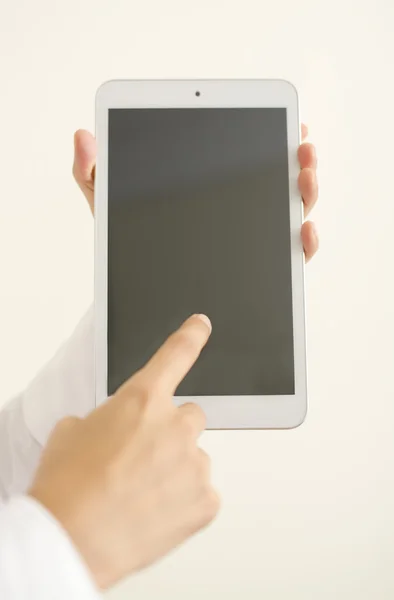 Woman hands holding a white tablet — Stock Photo, Image