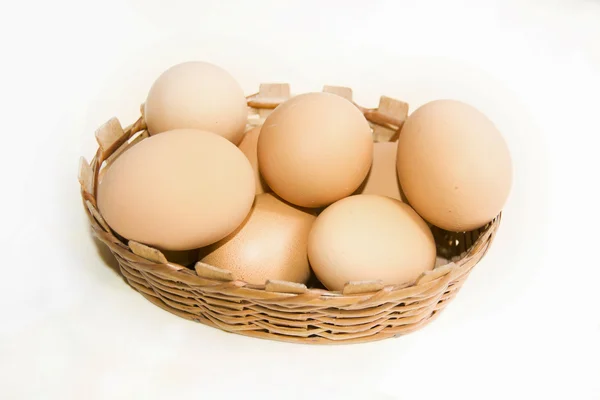 Brown eggs in basket isolated on white background — Stock Photo, Image
