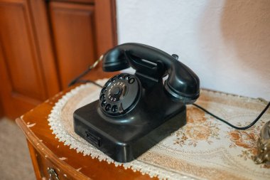 Vintage Rotary Telephone on Wooden Table. High quality photo