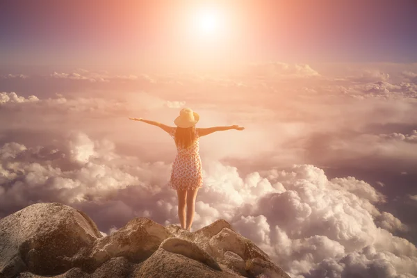 Freedom young  woman jumping on mountain peak rock — Stock Photo, Image