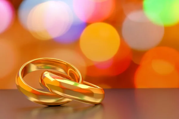 Couple of gold wedding rings on bokeh background — Stock Photo, Image