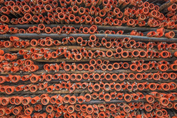 Red plastic tubes in the warehouse. — Stock Photo, Image