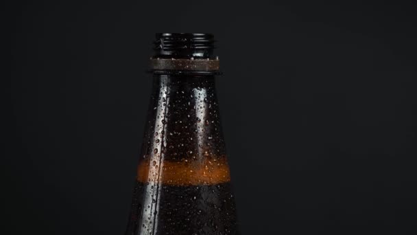 Plastic beer bottle on black background — Stock Video