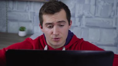 Bir adam dizüstü bilgisayar kullanıyor.