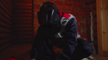 Adam metalin üzerine kaynak yapıyor.