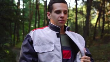 Bir adam iş gününden sonra üniformasını çıkarır.