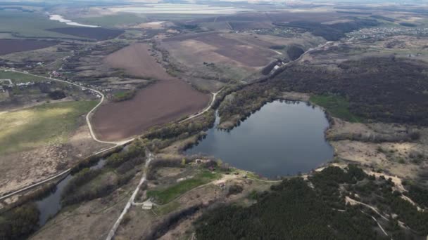 Luchtfoto van land bestaande uit bossen, meren en velden — Stockvideo