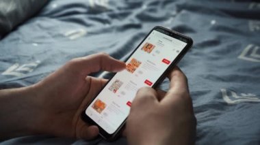 man orders sushi through the phone. Moscow, Russia. May 12, 2021.