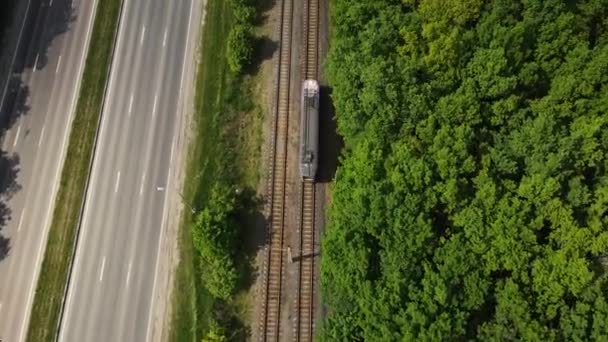 Pohyb dronu za tramvají podél lesa a silnice — Stock video
