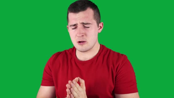 Man sneezes on green screen — Stock Video