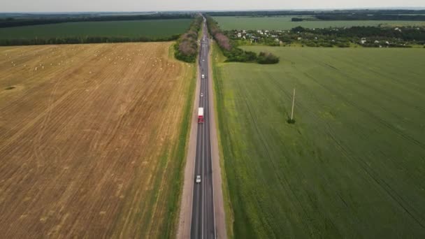 Movement of cars on the highway among the fields. aerial shooting — Stock Video