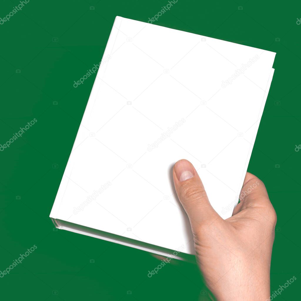 Mockup. Men's hands holding closed book with blank cover on light background