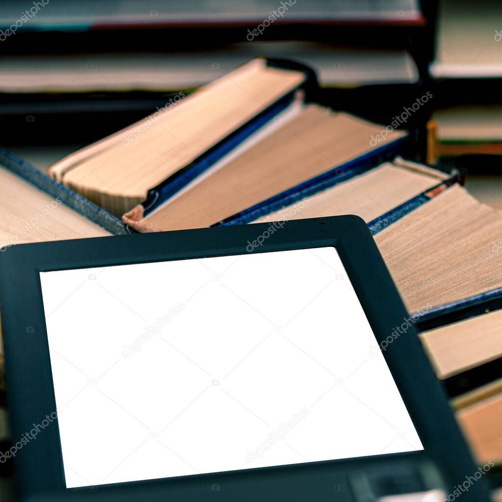 An e-book with a white screen and a place for text is on a shelf with old books