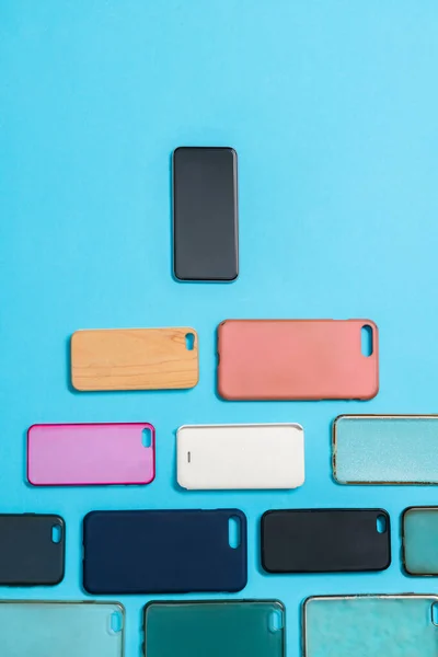 Pile Multicolored Plastic Back Covers Mobile Phones Blue Background Phone — Stock Photo, Image