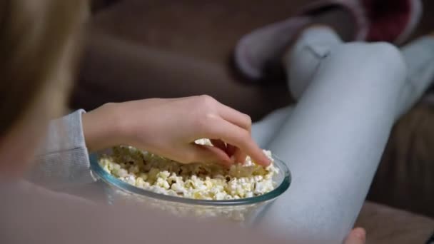 Close Hand Taking Popcorn Bowl While Watching Person Sitting Comfortable — Stock Video