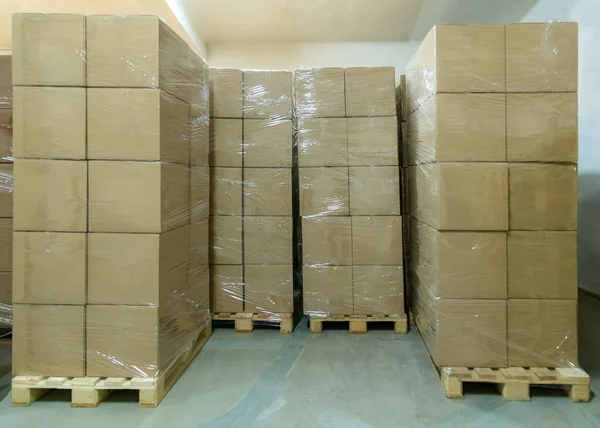 Stack of cardboard boxes ready to be shipped of a warehouse. Package storage room.