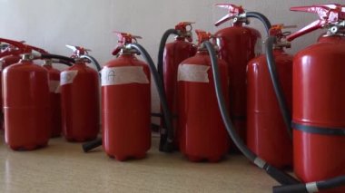 Duvarın yanında, sönmüş yangın söndürücüleri var. İşletmeler için yangın söndürücülerin yenilenmesi. 