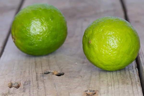 Lime on an old wooden tableLime — Stok fotoğraf