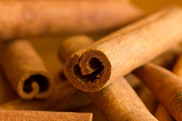 Cinnamon wide from close on a wooden table — Stock Photo, Image
