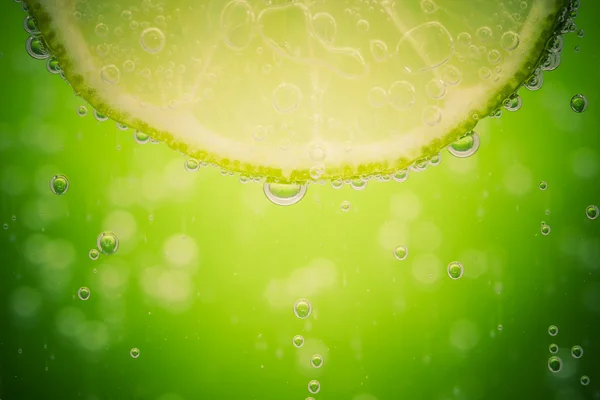Green lime with water splash — Stock Photo, Image