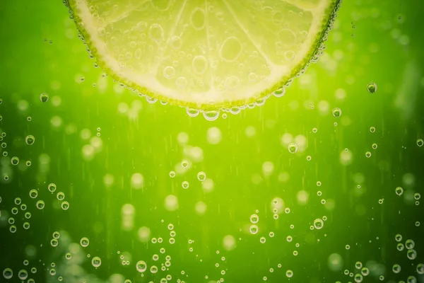 Green lime with water splash — Stock Photo, Image