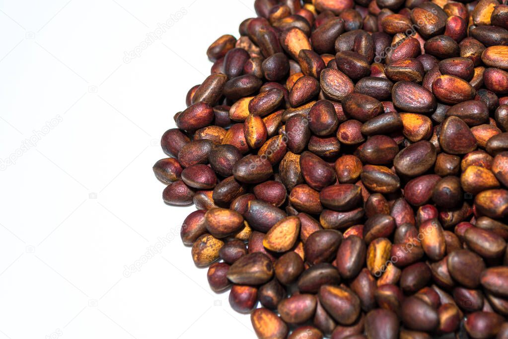 ripe pine nuts scattered on a white background