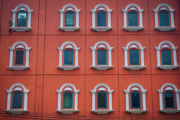 Vintage bright red building with white windows