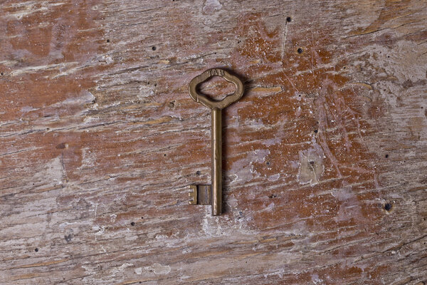 Single key on a old wooden table