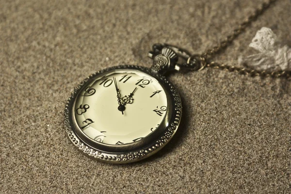 Antique clock in the sand — Stock Photo, Image